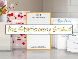 Storefront display for The Stationery Studio with the handwritten logo and colorful stationery accents in a bright shop setting.